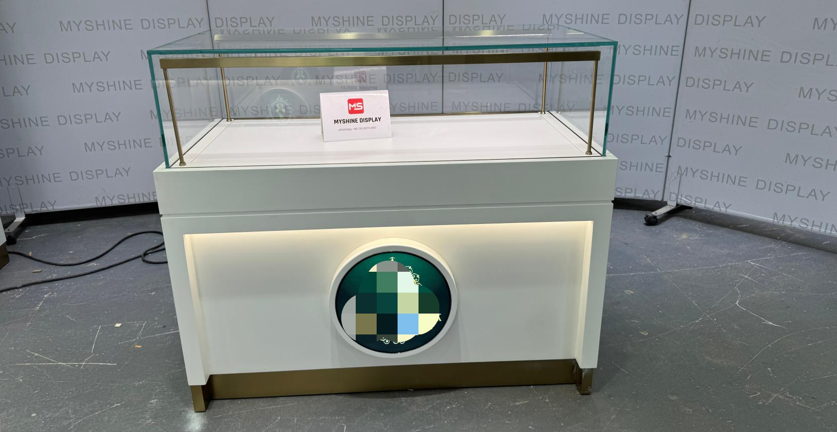 White & Gold Jewelry Display Counter with Circular Brand Accent