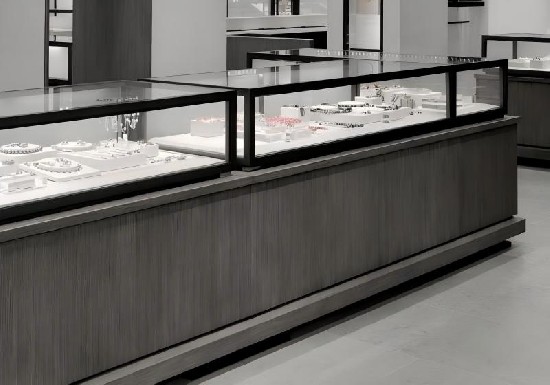 Minimalist Neutral-Toned Jewelry Display System: Sleek Stone & Wood Cabinets with Glass Cases for Contemporary Luxury Retail